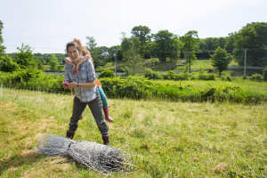 Farmer Whitney and Penny rolling up fencing